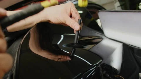Mechanic uses knockdown tool to remove dent on car in workshop Stock-Footage 316181614