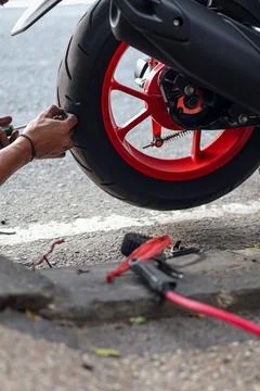 ​A mechanic uses a tool to remove a sharp metal screw Stock Photos