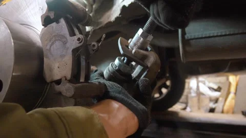 Mechanic using brake caliper piston tool for maintenance Stock Footage 326142221