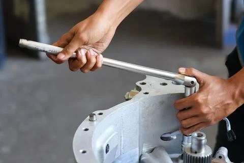 Mechanic using breaker bar in workshop. Stock Photos