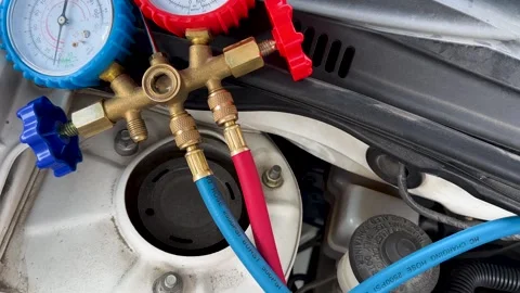 Mechanic Using A/C Manifold Gauge Set to Check Air Condition System Stock Footage 278588940