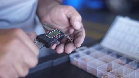 Mechanic using a caliper digital thickness gauge micrometer ruler slow motion Stock Footage