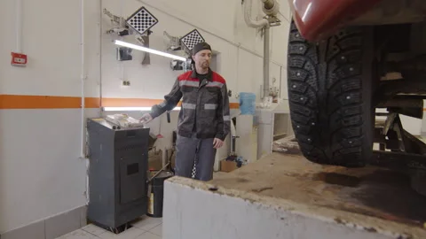 Mechanic Using Car Lift in Auto Repair Shop Video stock 169699809