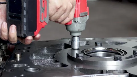Mechanic Using Cordless Impact Wrench To Fasten Engine Flange Bolt. Stock Footage 344677103