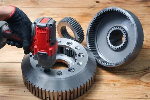 Mechanic Using Cordless Impact Wrench on Planetary Gear Carrier. Stock Photos