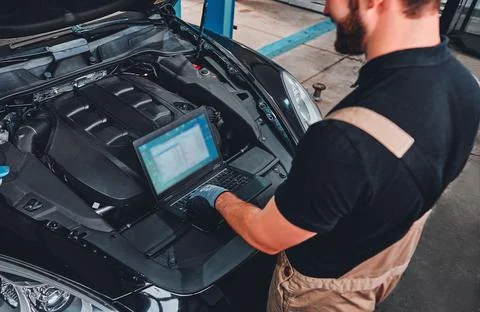 Mechanic using Diagnostic machine tools ready to be used with car. Stock Photos