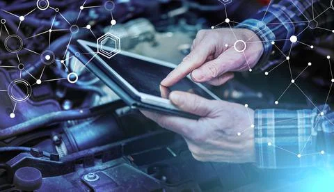 Mechanic using digital tablet for checking car engine; light effect 스톡 사진