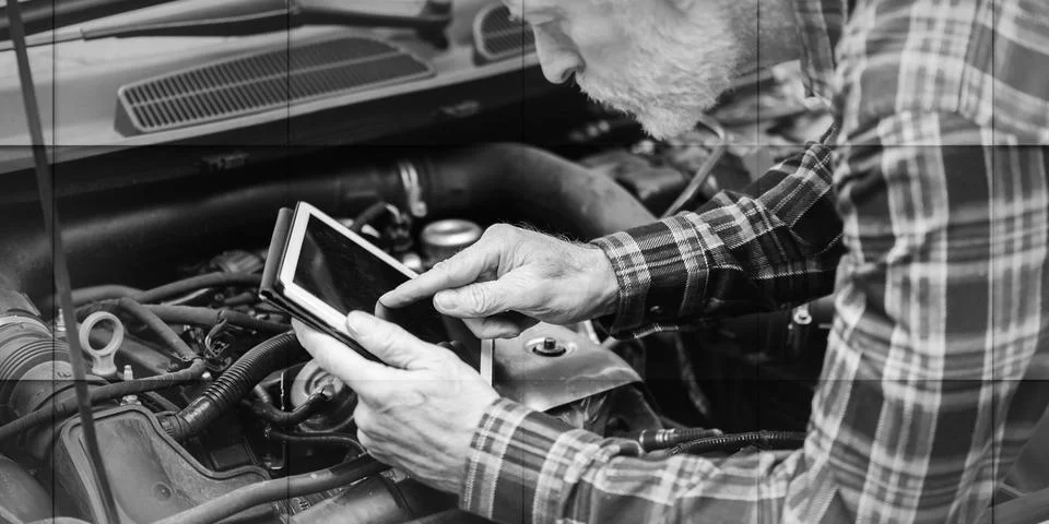 Mechanic using digital tablet for checking car engine, geometric pattern Stock Photos