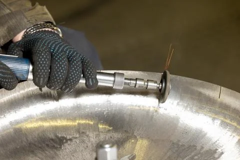 The mechanic is using a grinding machine Stock Photos