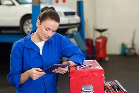 Mechanic using her tablet pc 스톡 사진