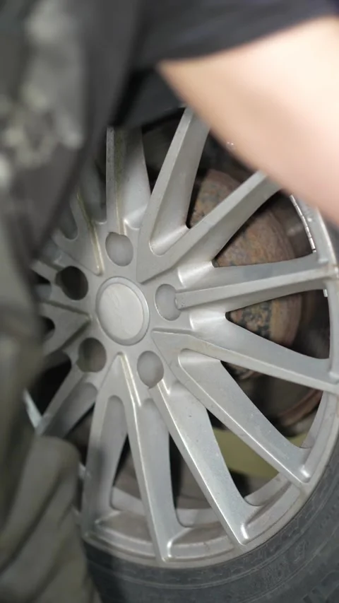 Mechanic Using Impact Wrench on Car Wheel Bolt in Auto Workshop Stock Footage 346119807