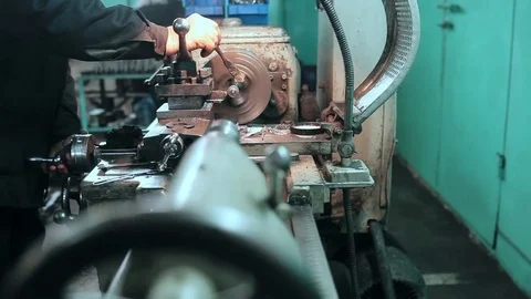Mechanic using industrial lathe machine Stock Footage 70567064