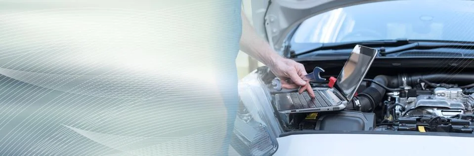 Mechanic using laptop for checking car engine. panoramic banner Stock Photos