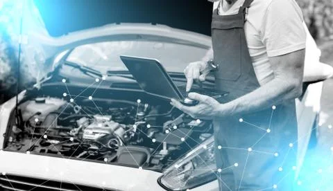 Mechanic using laptop for checking car engine; light effect 스톡 사진