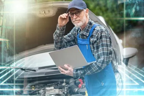 Mechanic using laptop for checking car engine; multiple exposure 스톡 사진