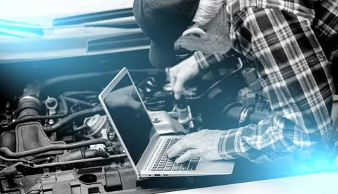 Mechanic using laptop for checking car engine; light effect Stock Photos