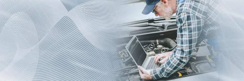 Mechanic using laptop for checking car engine; panoramic banner Stock Photos