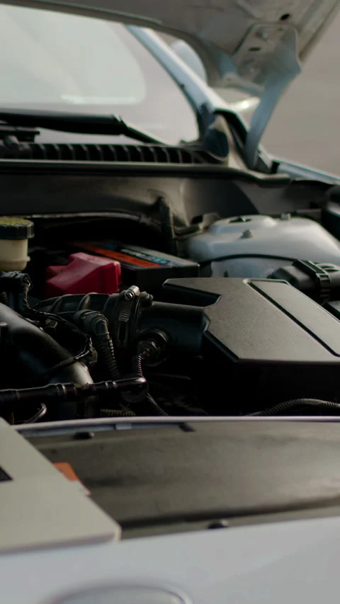 Mechanic using laptop with green screen to diagnose vehicle issues, showcasing Stock Footage 318031777