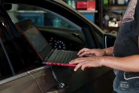 A mechanic using a laptop to perform car computer diagnostics. Foto stock