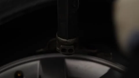 A mechanic using a machine to mount a tire on a rim. Stock Footage 331941127