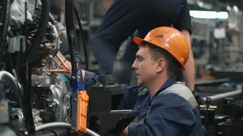 Mechanic Is Using Manual Tools To Assemble Automobile At Industrial Plant Stock Footage 271592794