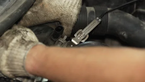 Mechanic using a metal clamp tool on car radiator hose. Stock Footage 341487435