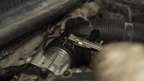 Mechanic using a metal clamp tool on car radiator hose. Stock Footage 341487533