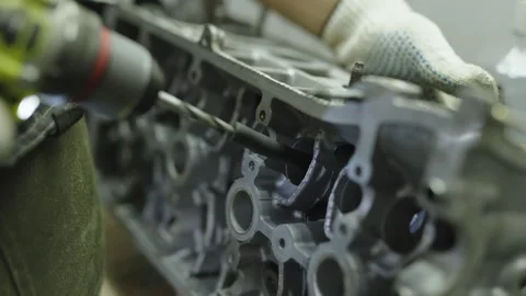 Mechanic using power drill to ream camshaft tunnel in engine Stock Footage 340273754