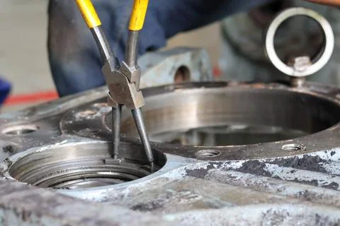 Mechanic Using Retaining Ring Pliers on Machinery. Stock Photos