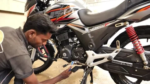 Mechanic Using Small Brush To Clean Engine On Honda CBF150F. Slow Motion Video stock 197817209