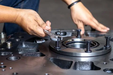 Mechanic Using Spanner Wrench On Heavy Industrial Machine Bearing Flange. Stock Photos