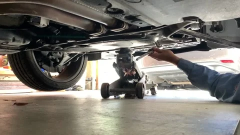 Mechanic Using Wrench Under a Car Stock Footage 136868962