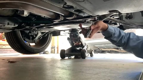 Mechanic Using Wrench Under Car Stock Footage 136868997