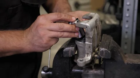The mechanic, we fasten the nut to the part from the machine on the vise. Stock Footage 337734580