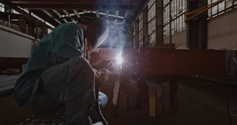 Mechanic welding while in warehouse Stock Footage 254934880