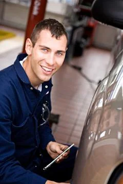 Mechanic: at work checking tire pressure Stock Photos