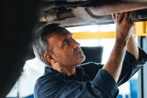 Mechanic at work in his garage Foto stock