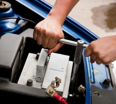 Mechanic at work, process of changing the car battery, closeup s Stock Photos