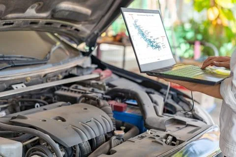 Mechanic work tune torque engine in ecu with laptop computer. Stock Photos