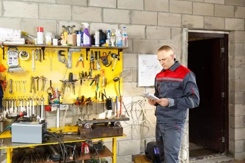 Mechanic worker studying his instructions Stock Photos