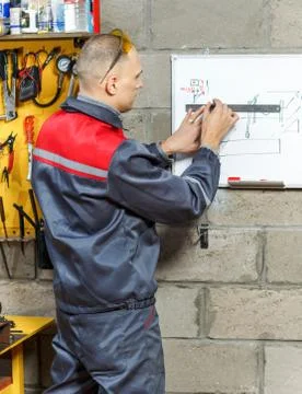 Mechanic worker studying his instructions Stock Photos