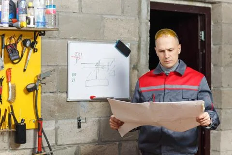 Mechanic worker studying his instructions Stock Photos