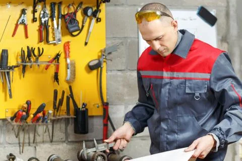 Mechanic worker studying his instructions Stock Photos