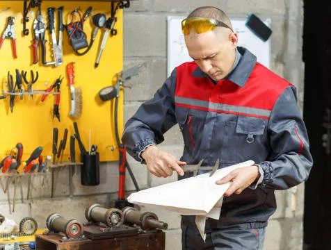 Mechanic worker studying his instructions Stock Photos