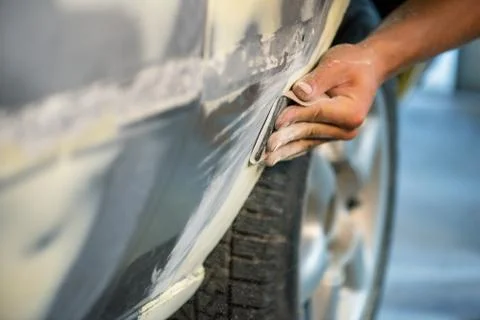 Mechanic working in auto shop. Stock Photos