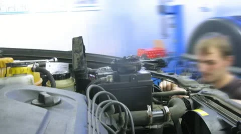 Mechanic working at car with battery on close view. Time lapse Stock Footage 14840559