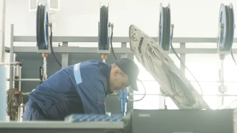 Mechanic working on a car engine Stock Footage