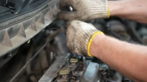 Mechanic working on car engine with gloved hands Video stock 347642602