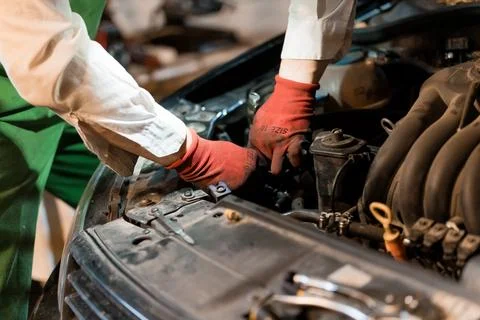 Mechanic Working on Car Engine with Tools in Workshop Stock Photos