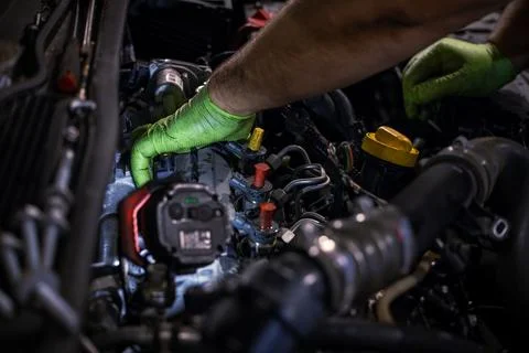 Mechanic Working on Car Engine under the hood Stock Photos